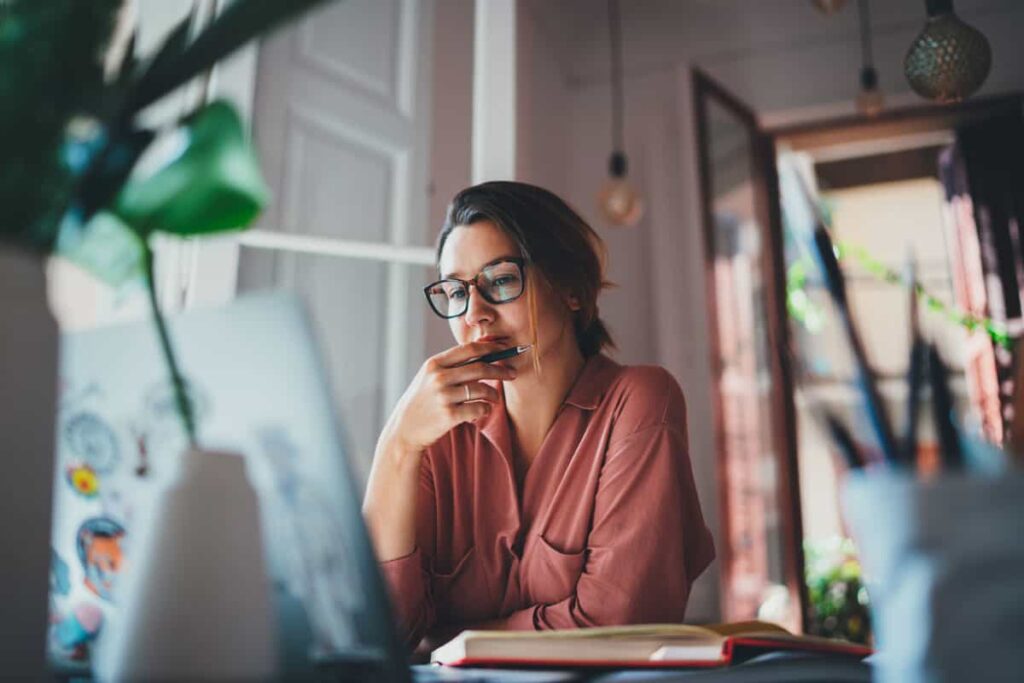 Woman at computer thinking